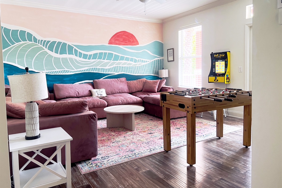Fun hangout space on second floor with a 65" TV, arcade and foosball table