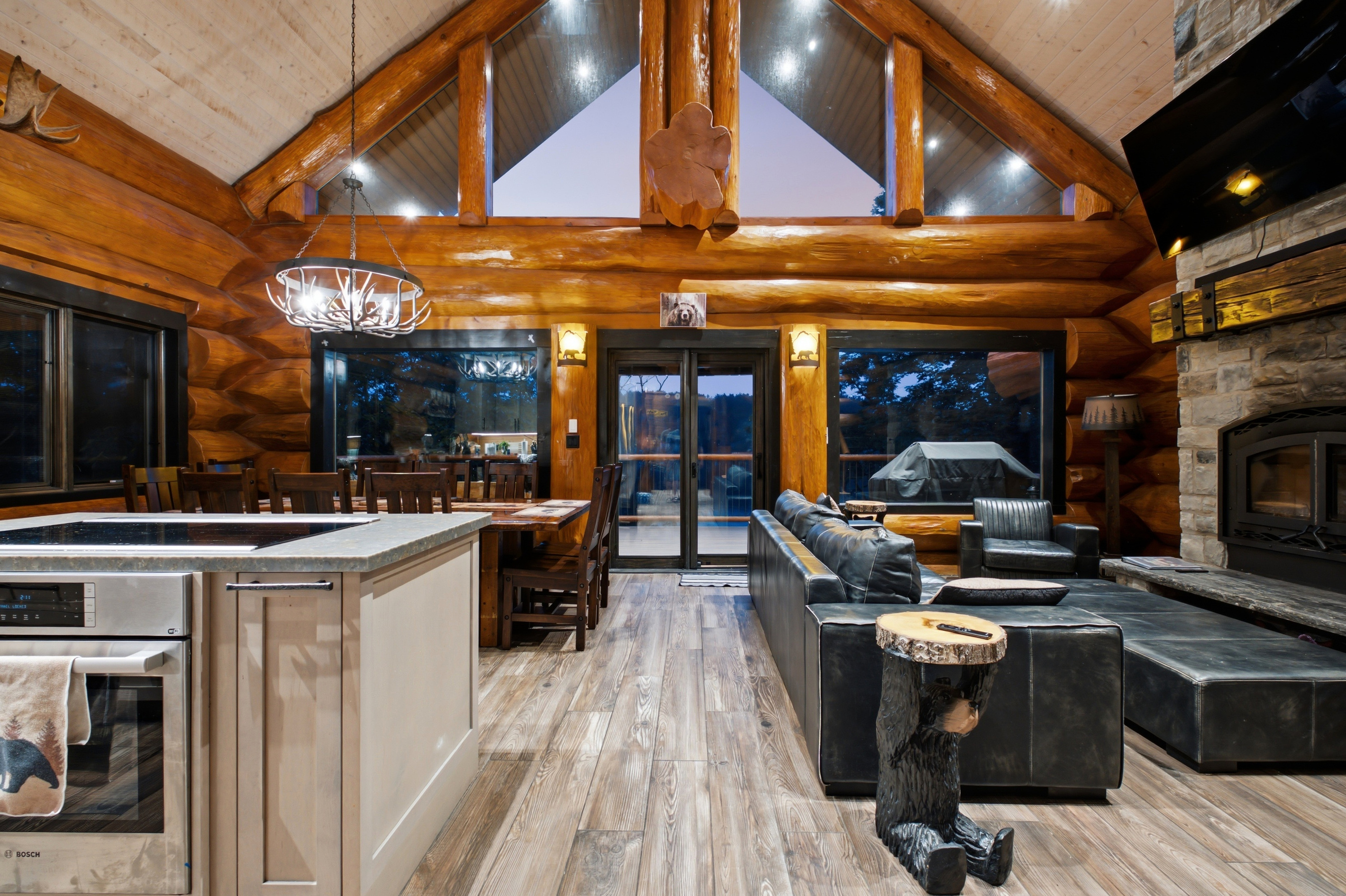 Open-concept great room with vaulted ceilings and modern lodge interior