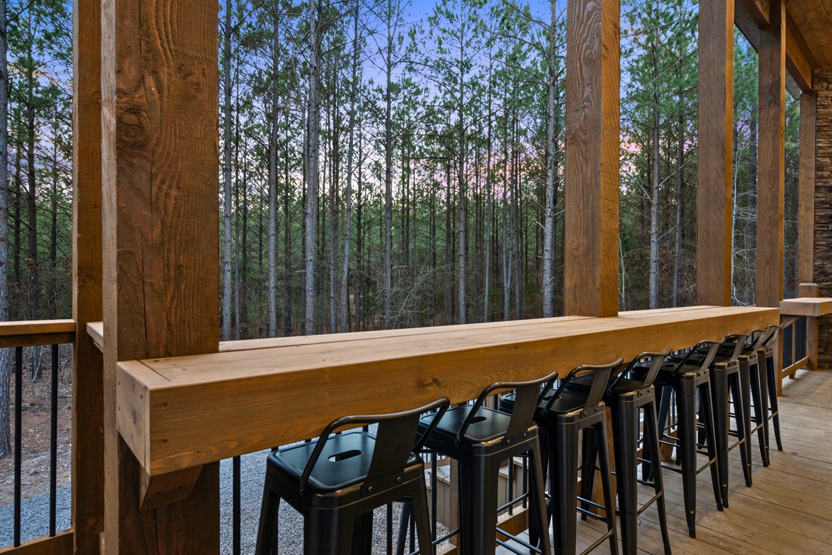 A long bar-style counter along the deck gives guests a great place to sit, chat, and take in the views of the surrounding woods.