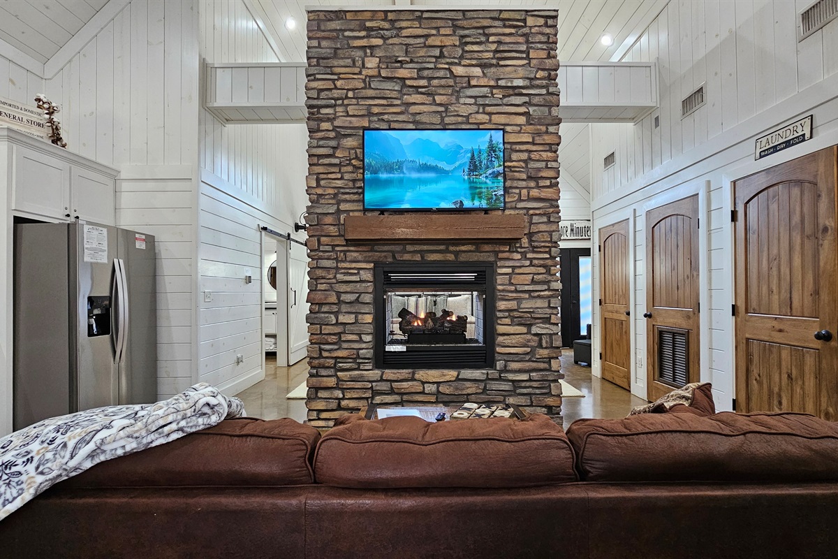 Living Room: Gather around the stunning stone fireplace for game nights and movie marathons!