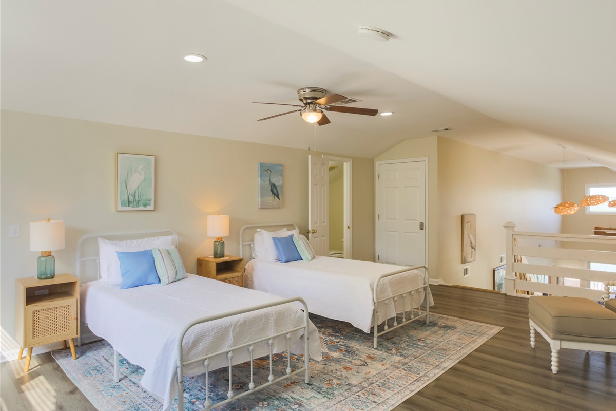 Charming loft with twin beds and a half bath — ideal for kids or extra guests.