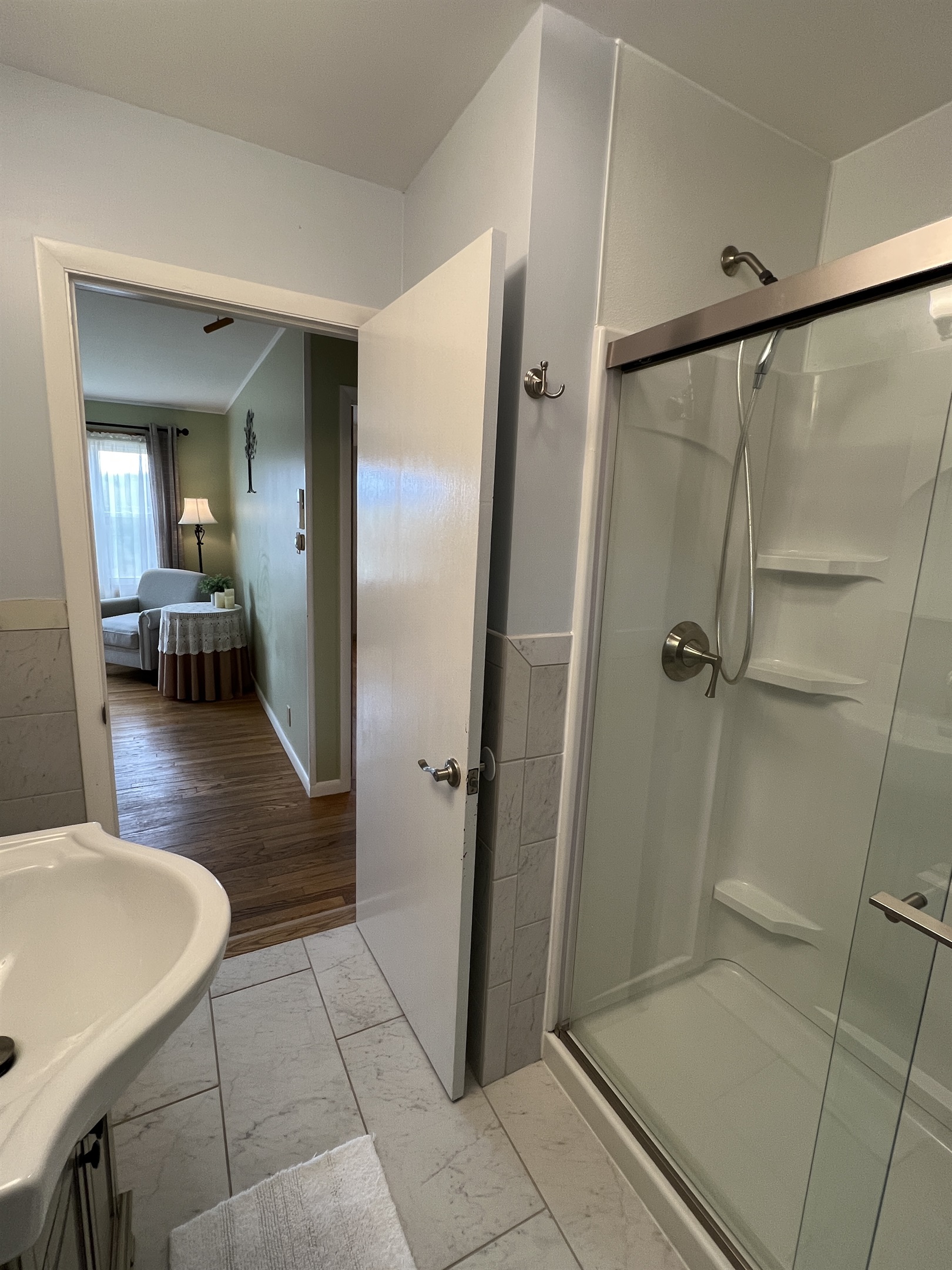 Full bathroom on the main level view into the living room.