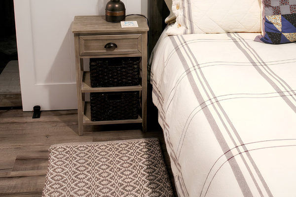 "Vete" bedroom suite features barn door to the bathroom with a shower