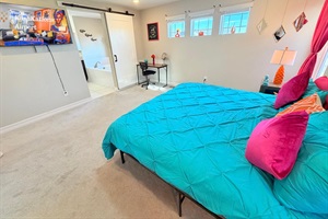 Primary king ensuite with large tub, separate shower, private toilet, and sinks