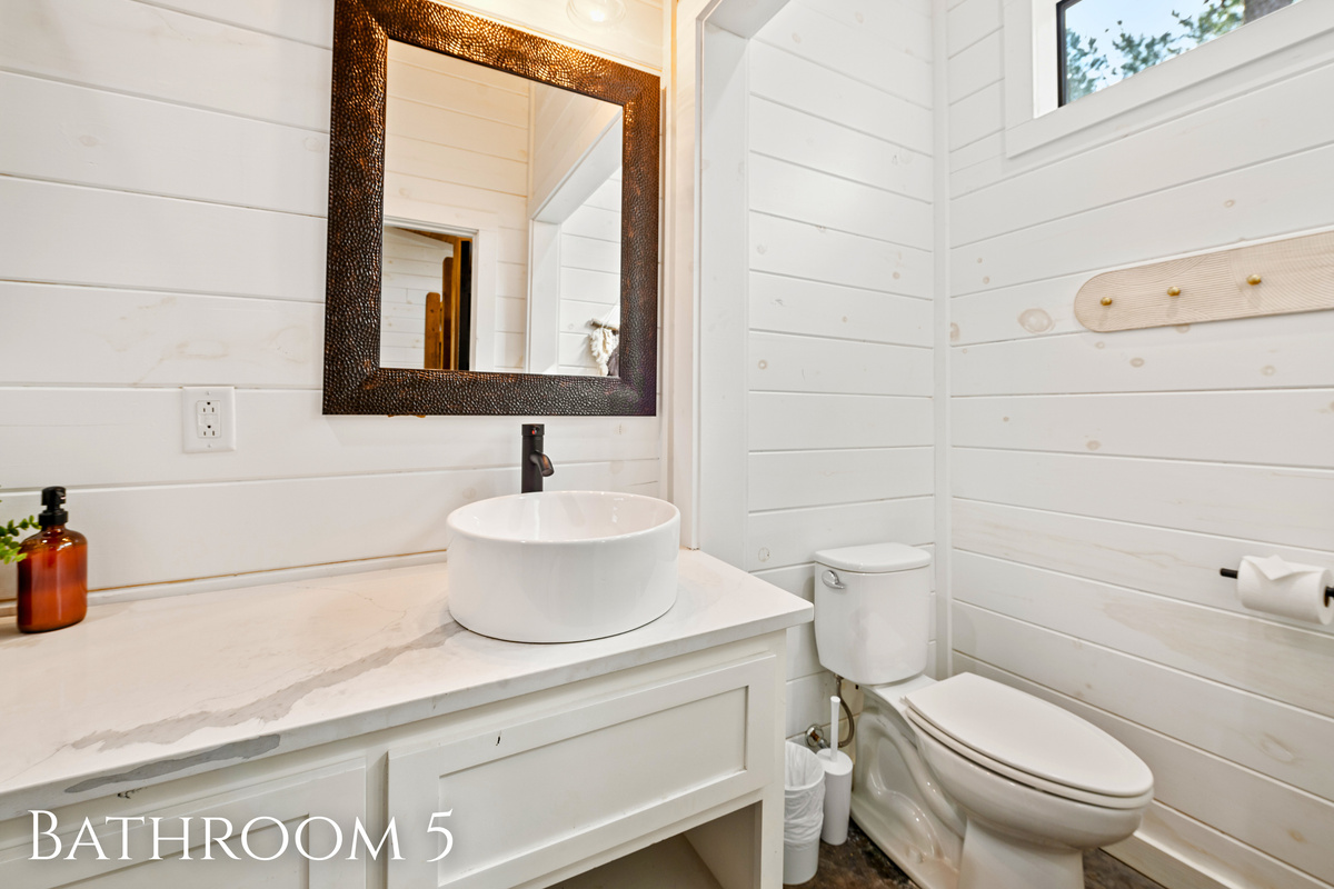 Freshen up in this chic, minimalist bathroom before heading out for a day of adventure or a night of campfire stories.