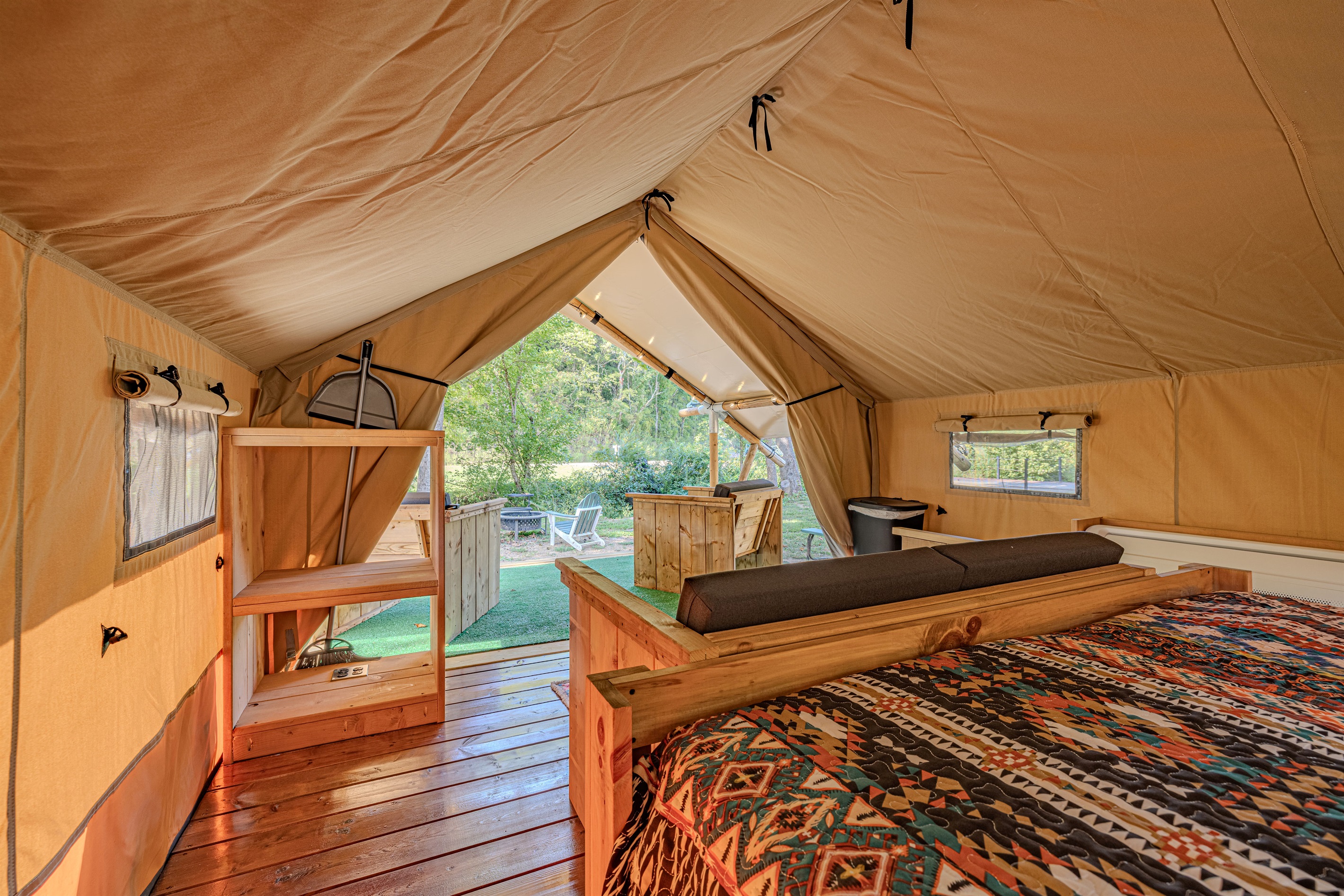 Your peaceful hideaway. The warm lighting and colorful bedding make this tent a true sanctuary. Glimpse the forest through your window screen while you settle in for the night.