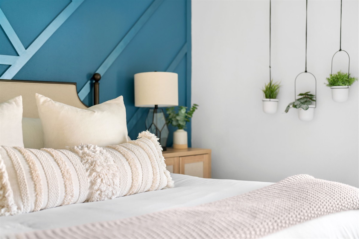 Embrace the feeling of pure bliss in our bedroom, where a generously-sized bed and an array of sumptuous pillows create a sanctuary of tranquility and comfort.