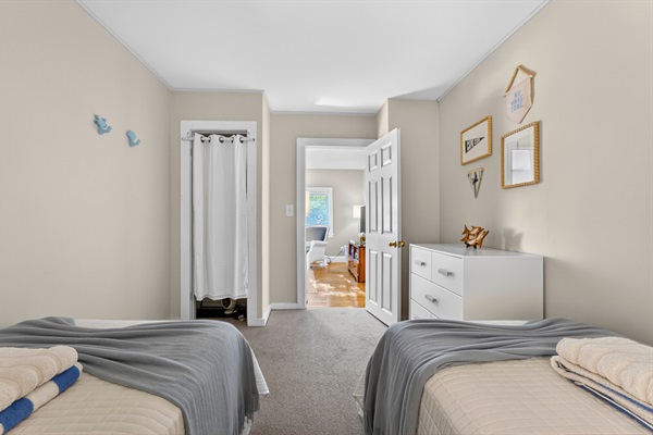 A comfortable bedroom with 2 single beds suitable for those traveling with kids.