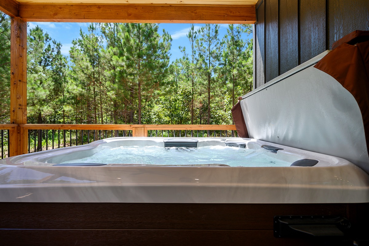 Soak in your private hot tub surrounded by tall pines—pure relaxation at our Broken Bow cabin retreat