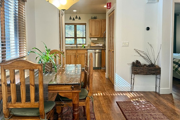 The layout flows seamlessly from the living room through the dining area into the kitchen.