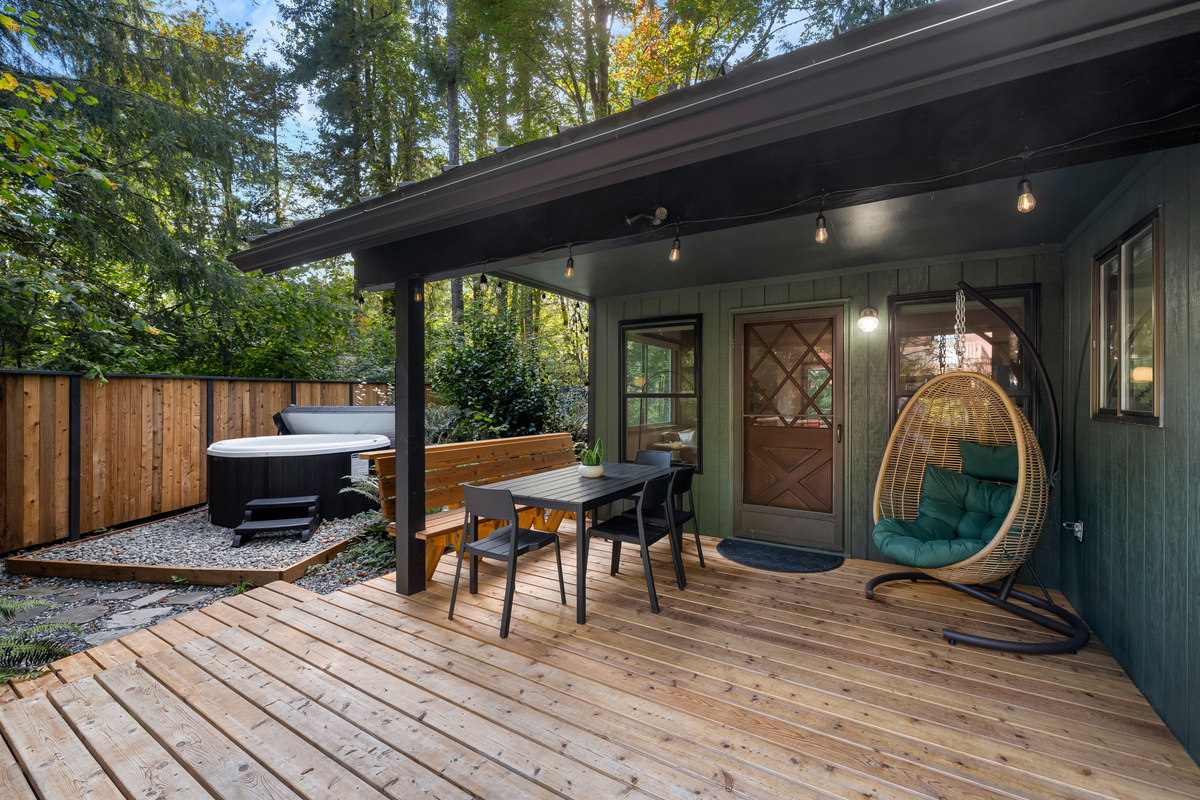 Dinner table, hot tub, hanging chair — this deck does it all.