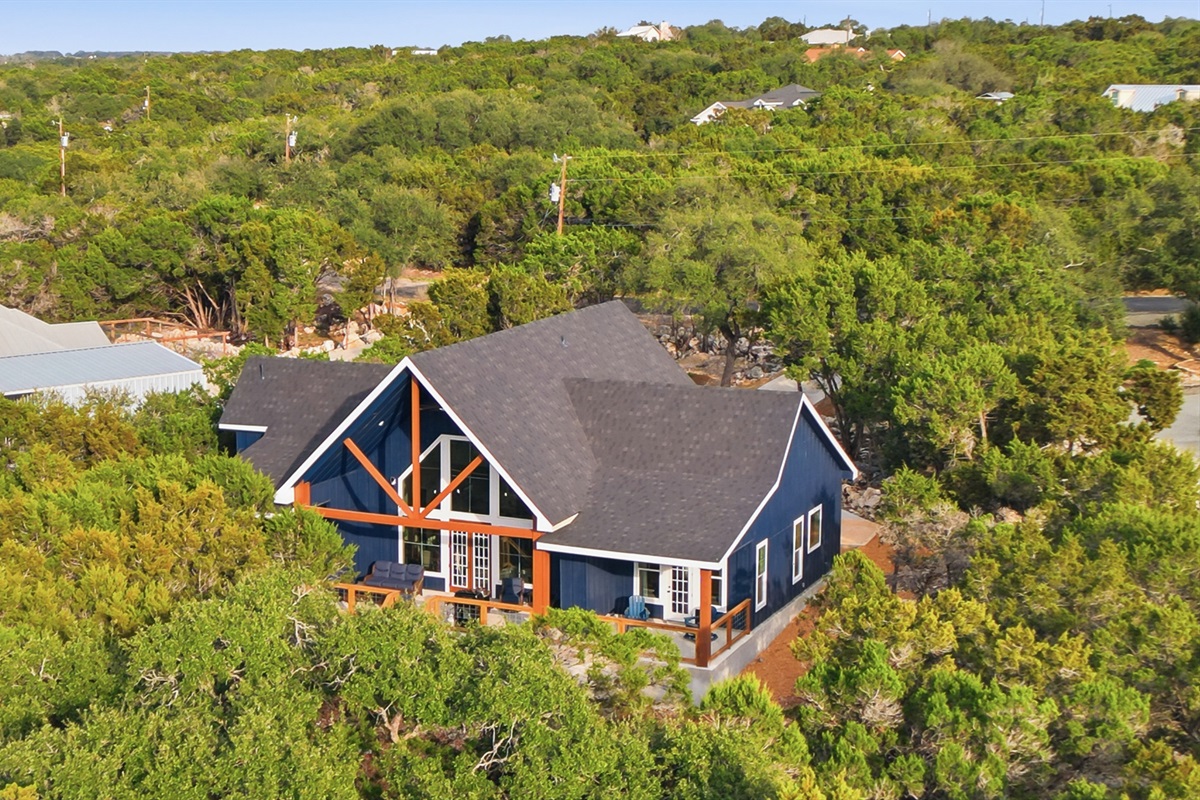Dragonfly Ridge Estate surrounded by mature trees, offering privacy and space between Canyon Lake and Gruene.