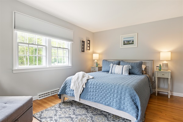 Step into our first bedroom with queen size bed!