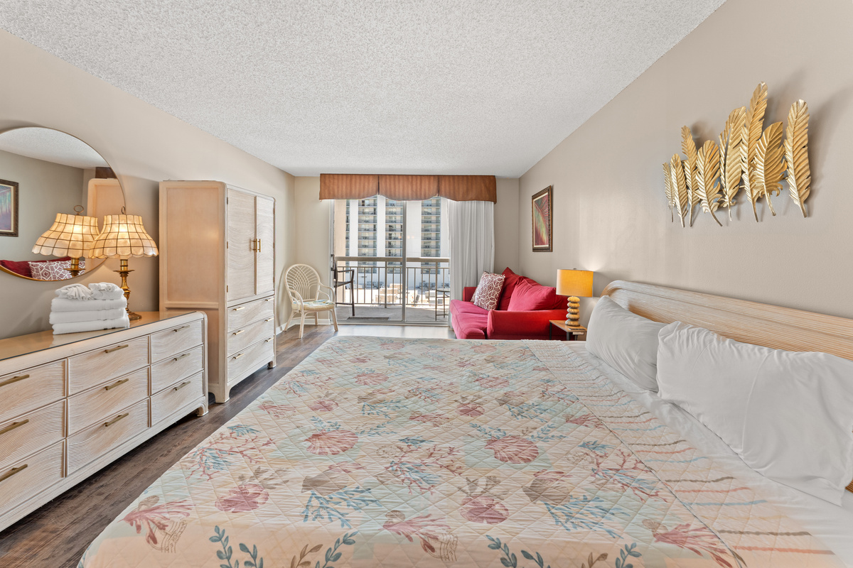 Spacious Main bedroom with King bed, balcony access, ensuite and a sofa bed.