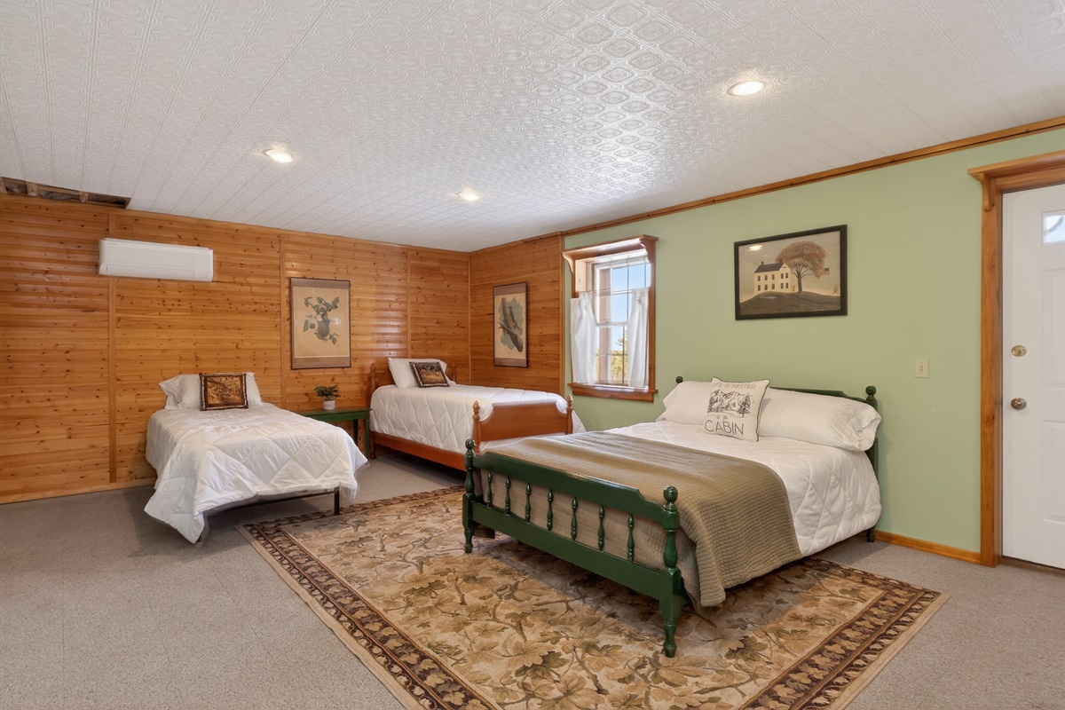 Lower level bedroom # 4 with two twins, a double bed and a queen futon 