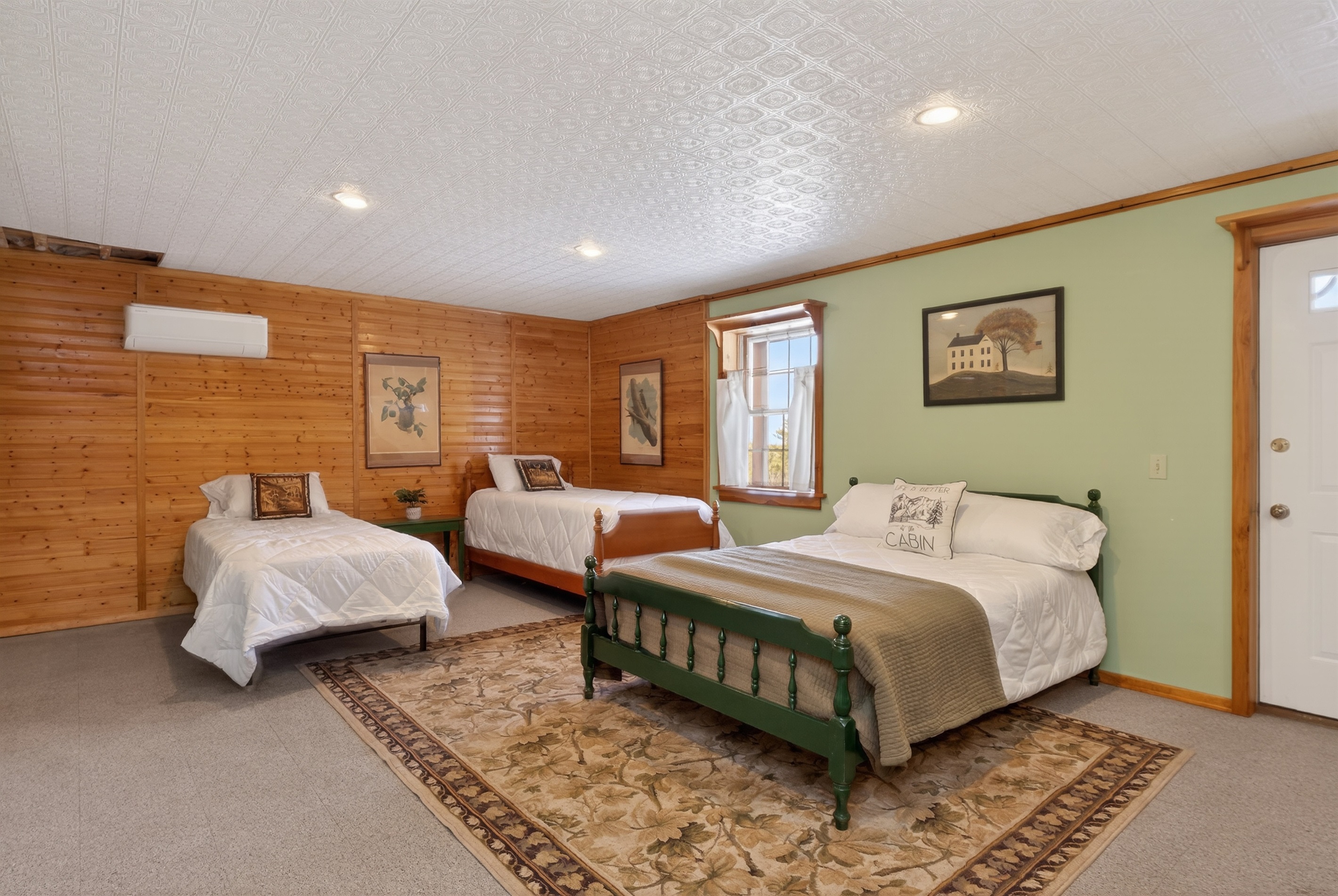 Lower level bedroom # 4 with two twins, a double bed and a queen futon 