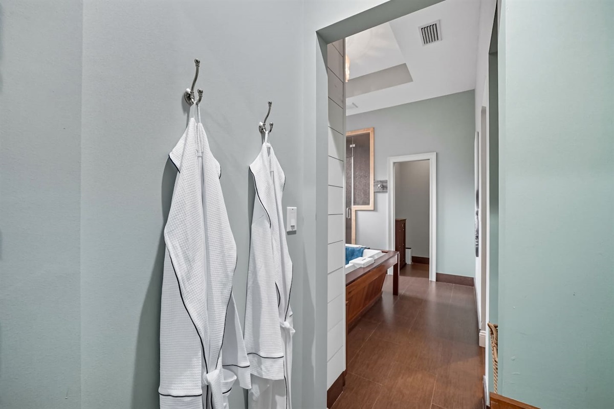 The master bathroom comes with his and hers robes.  Enjoy the smart shower then rest and relax in the king bed with full body massaging features.