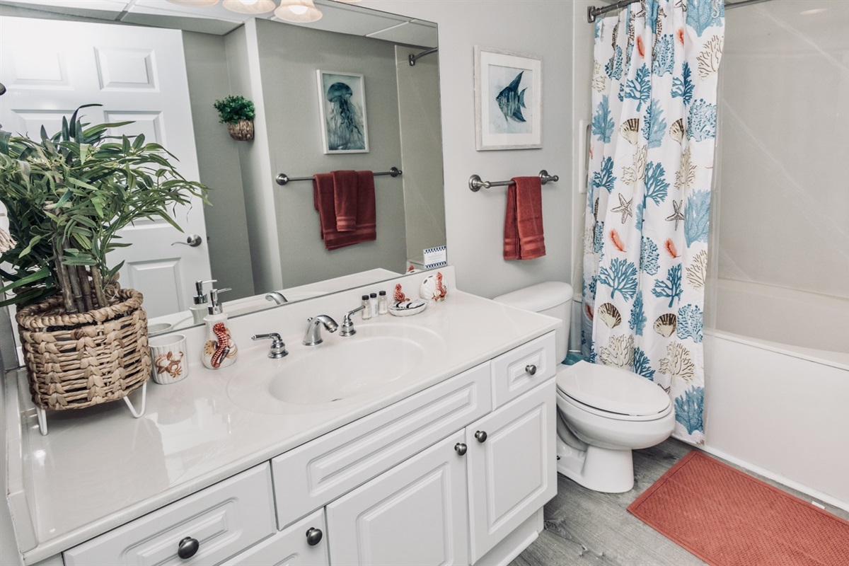 Guest/Hall Bath featuring shower, and deep soaker tub.