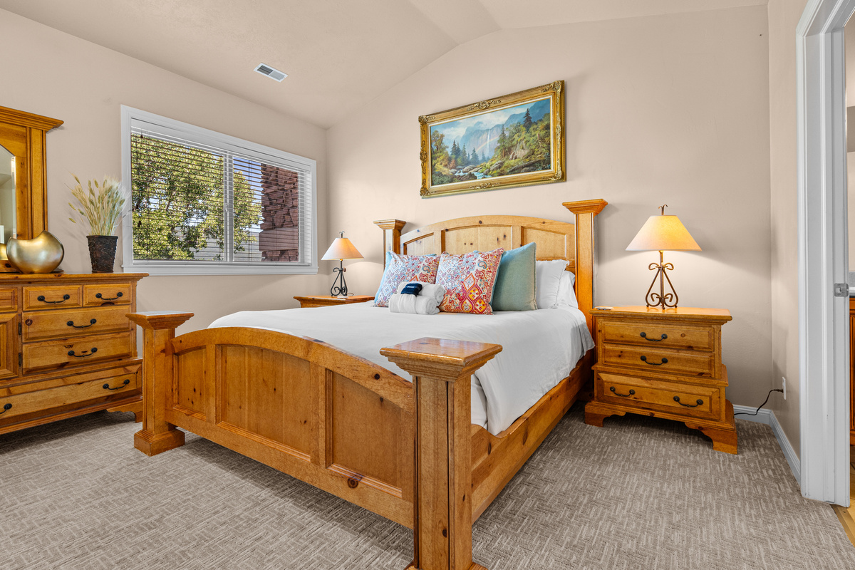 Airy primary suite with vaulted ceilings, warm finishes, and a relaxing, open feel.