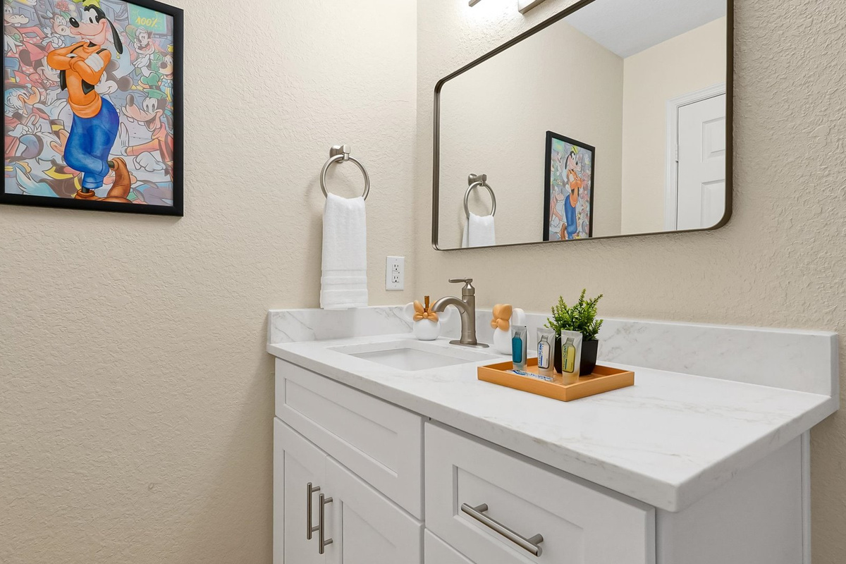 Mickey’s Rainbow Magic Bathroom – Bright vanity with generous counter space and character artwork