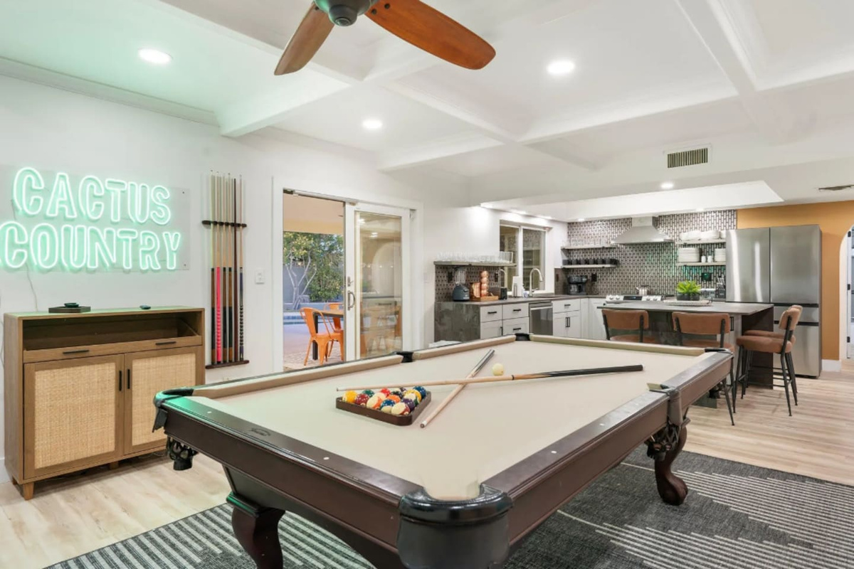 Another look at the game room shows the open flow between the pool table, kitchen, and lounge, easy sightlines for staying part of the group.