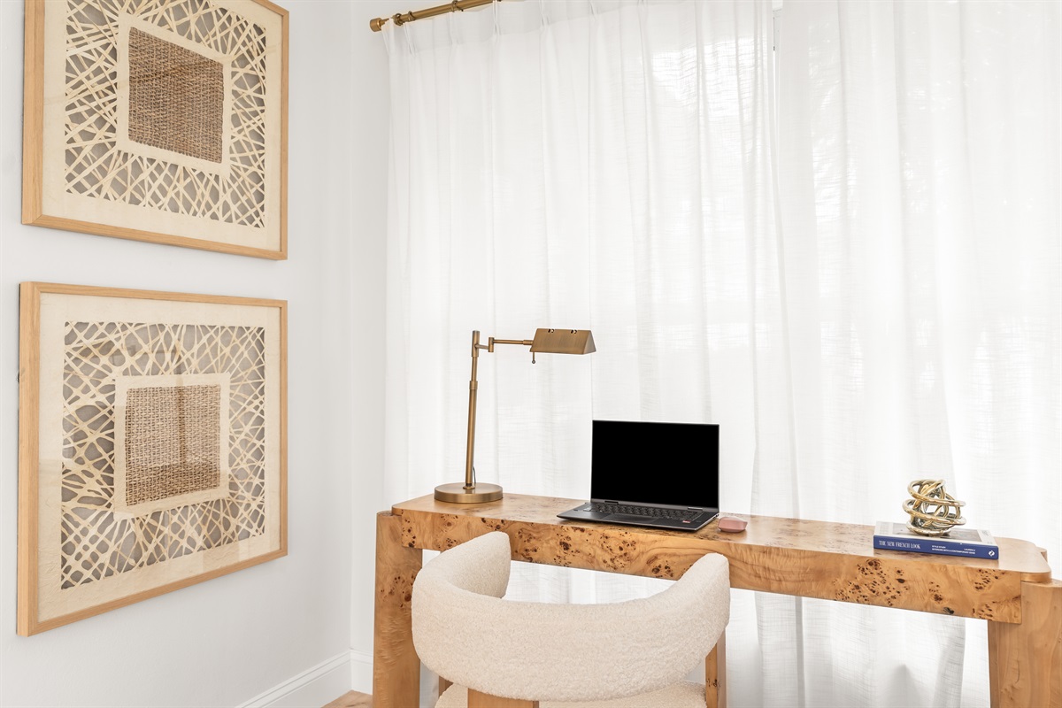 A beautifully crafted wood desk and soft boucle seating create an inspiring place to focus.