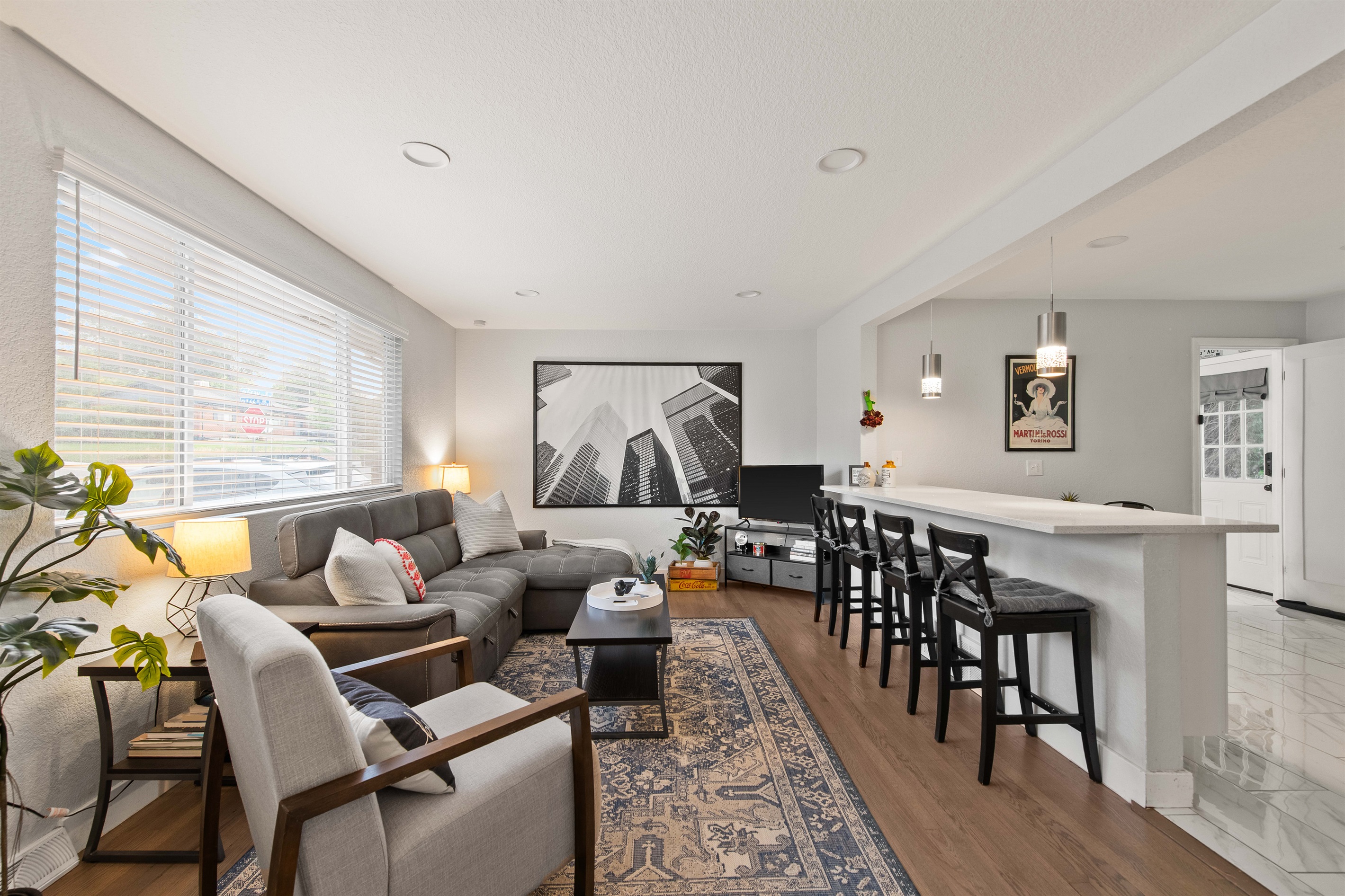 Spacious main living area with natural light and bar seating