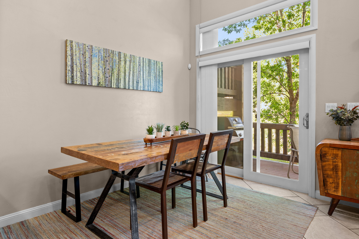 Sunlit dining space with easy access to the outdoor deck and mountain air.