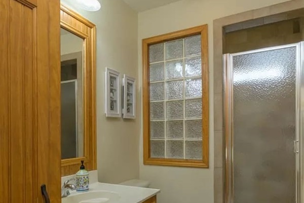 Ground floor bath servicing the bunk room and pool areas with walk-in shower with bath toiletries provided. 