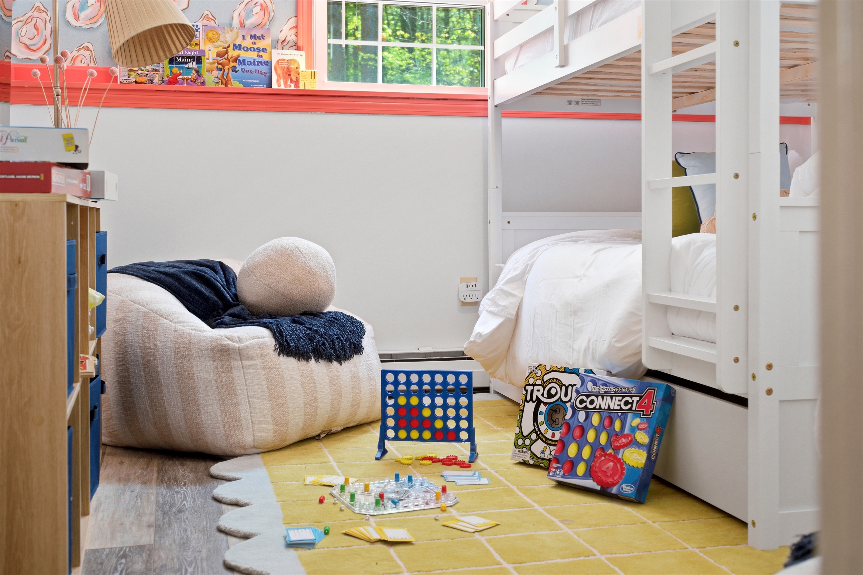 A comfortable bean bag set in a fun and inviting space with games nearby, perfect for lounging, playing, and enjoying relaxed moments together.