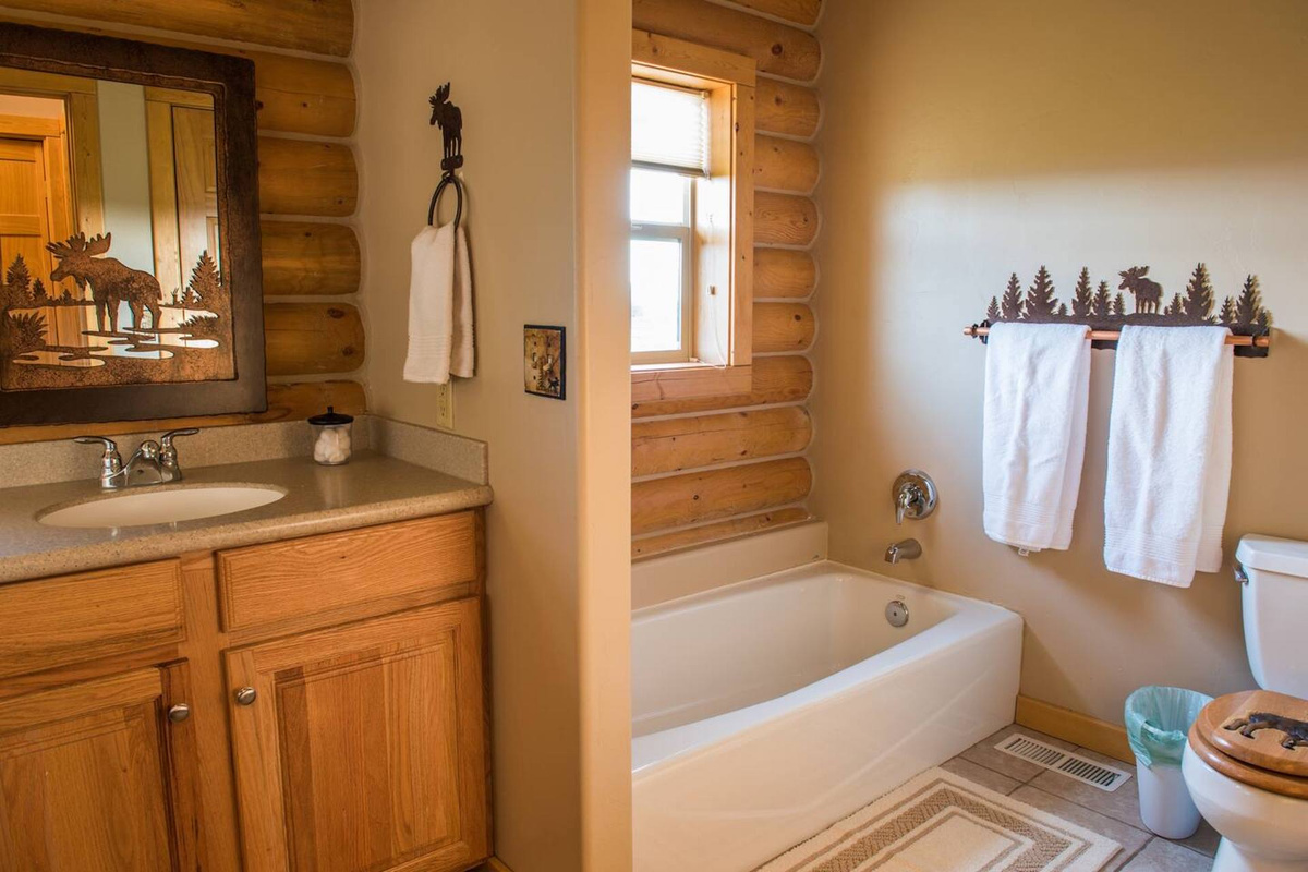 The roomy country-style bathroom has both a bath and a shower.
