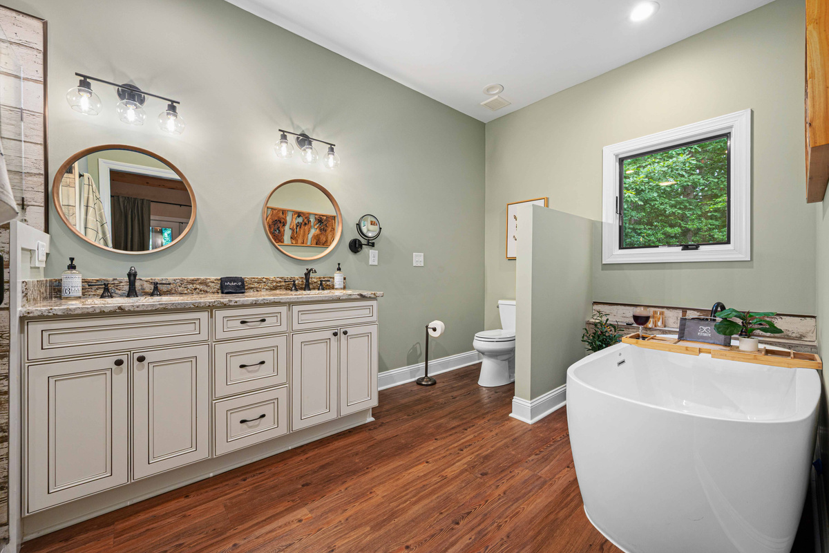 Luxurious en suite bathroom with a soaking tub, double vanity, and walk-in shower.