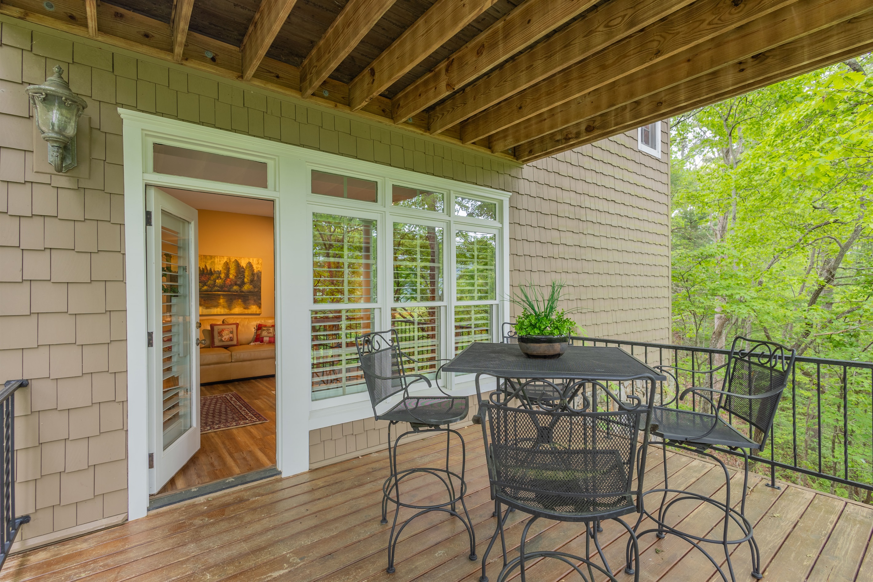 Step right outside from the lower-level suite and enjoy easy access to the covered deck nestled among the trees.