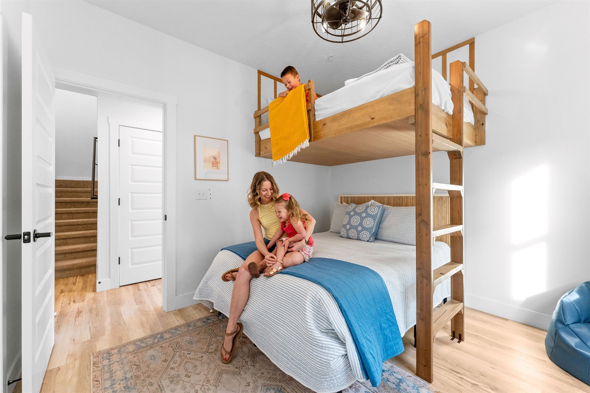 A fun bunk room with a queen bed and loft bed, perfect for families.