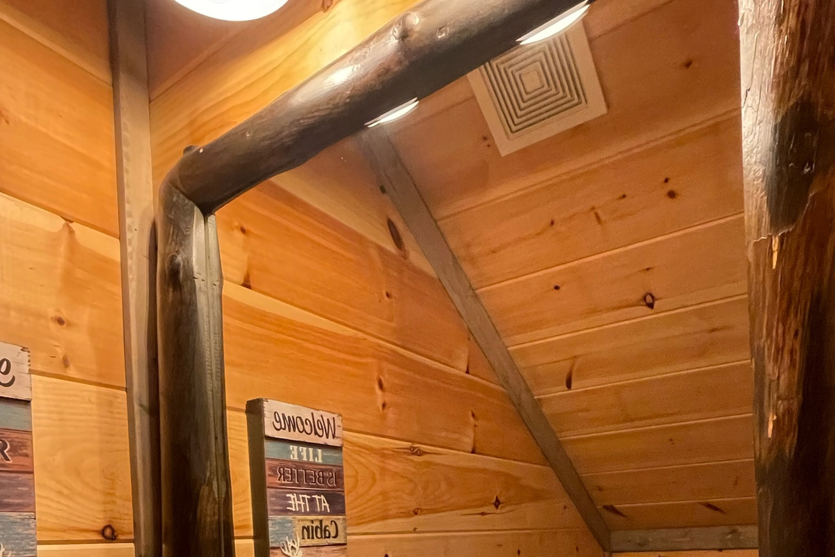 Cozy half bath under the stairwell is a well thought out feature of this cabin and limits the traffic to the beautiful master bedrooms!