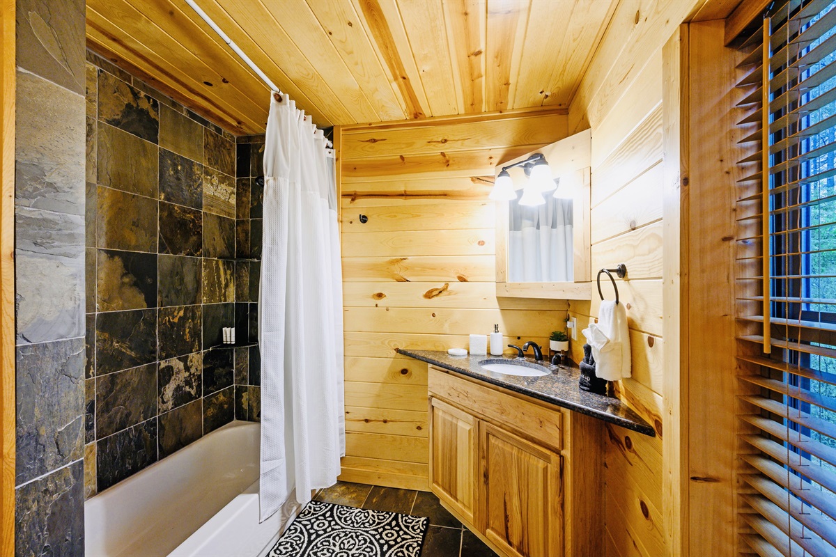 Stone clad shower with a Tub