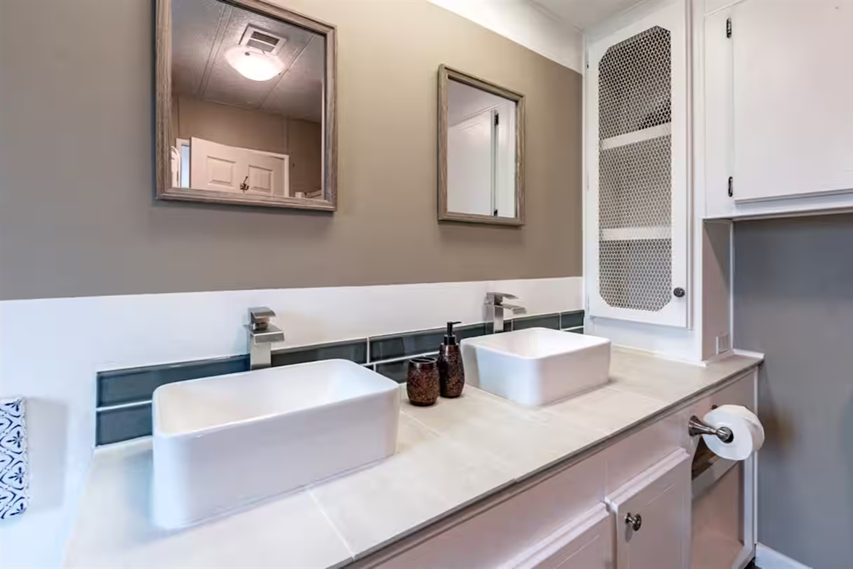 Stylish double vanity bathroom with modern fixtures and spa-like charm - Primary Ensuite.