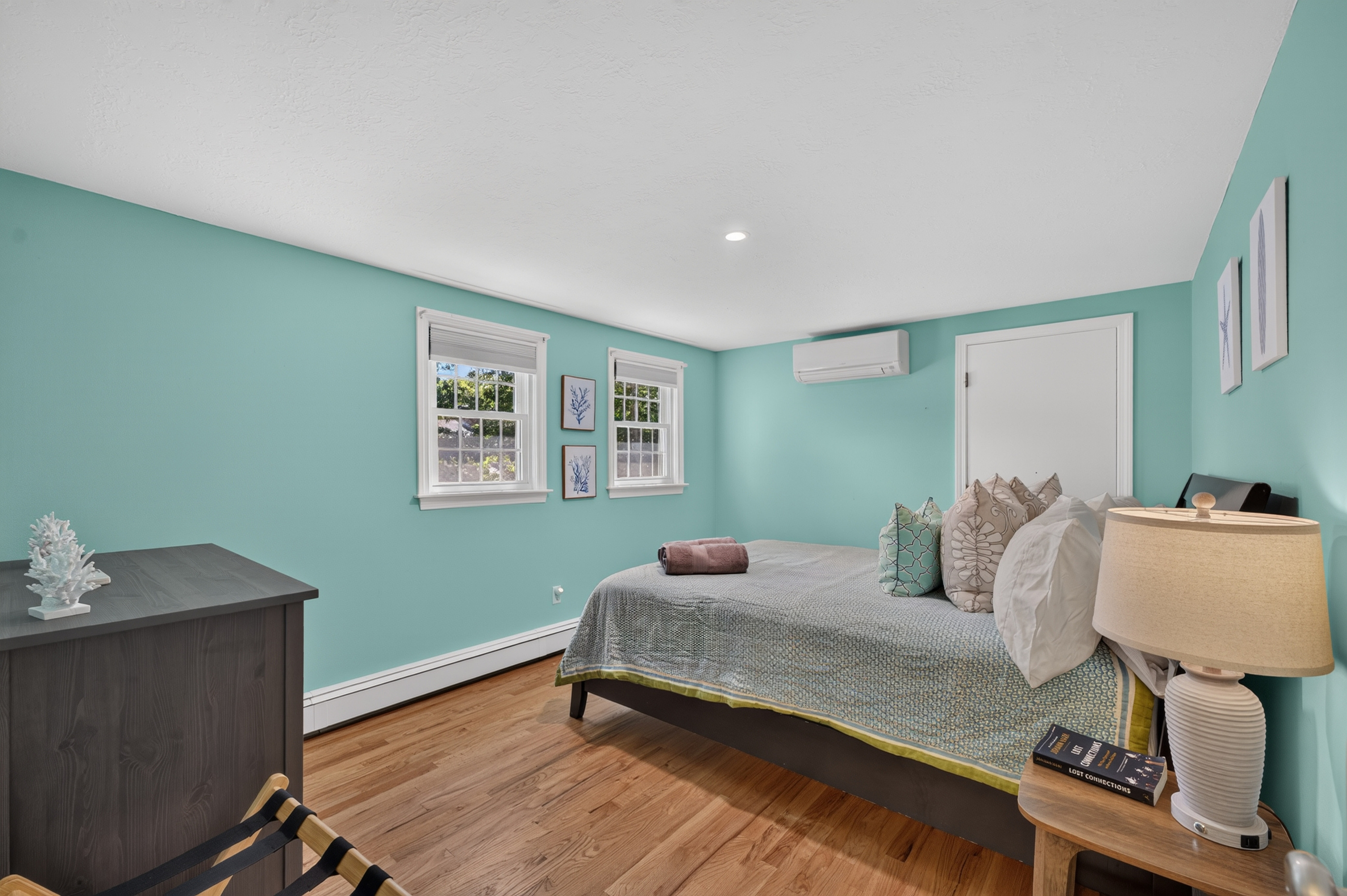 Peaceful bedroom with soft coastal colors and a comfortable queen bed.