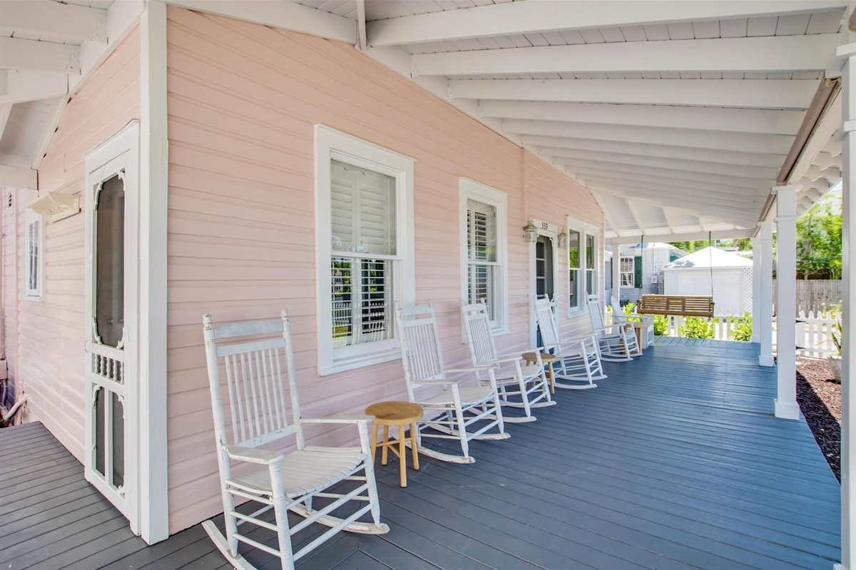 Back porch with rocking chairs and porch swing facing Maria Sanchez Lake