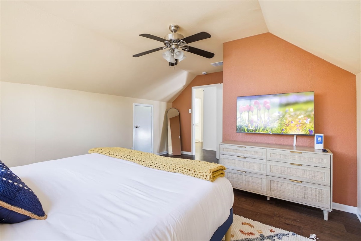 Second-floor bedroom with king bed and Roku TV