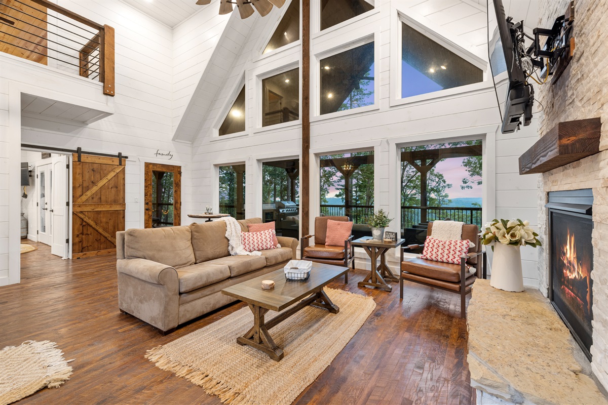 Spacious open-concept living room with soaring ceilings and warm rustic charm