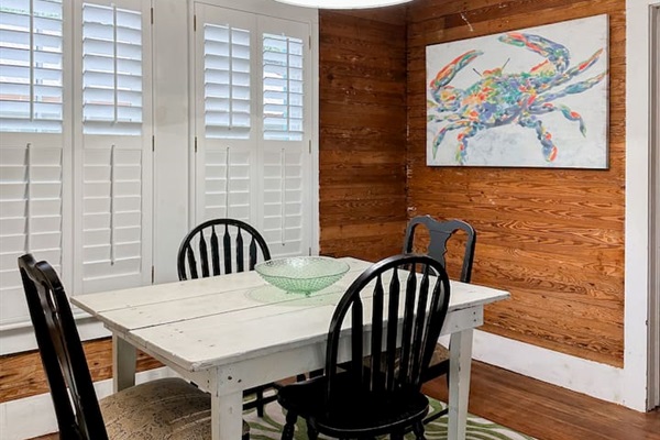 A table for 4 makes a cozy dining space with natural wood accents, bright light, and a welcoming setup for everyday dining.