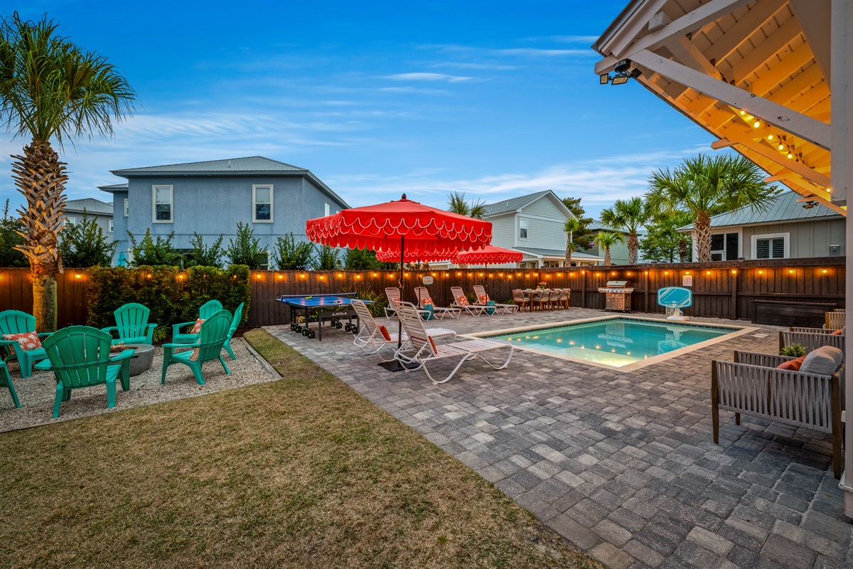 Evenings in Miramar Beach look like this. Private pool, glowing string lights, fire pit, and plenty of space to relax under the Florida sky.