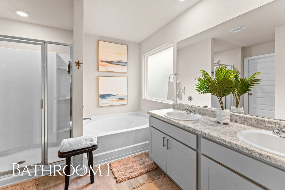 Bathroom 1 is spacious and bright, featuring dual sinks and plenty of room for everyone to get ready without feeling crowded.