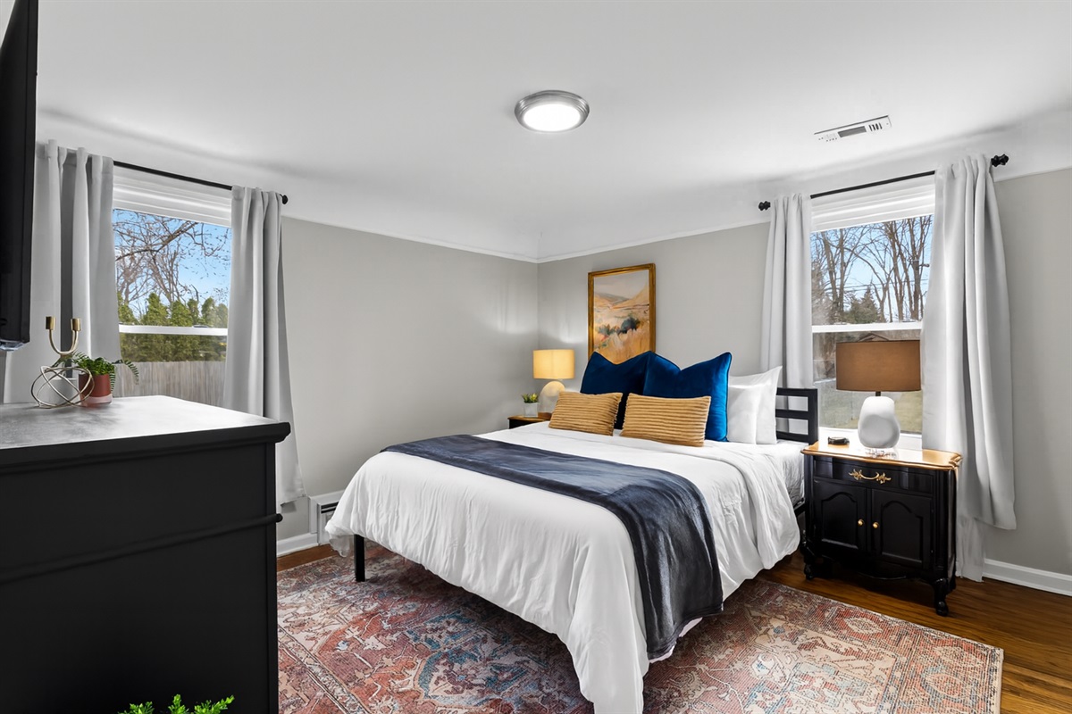 Bright & spacious bedroom offers both natural light and black out curtains