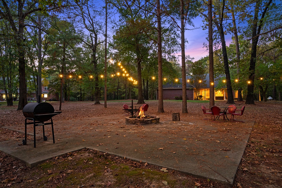 Outdoor seating and firepit area perfect for evenings under the lights.