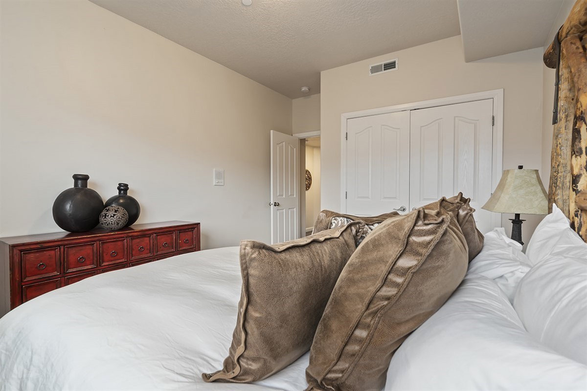 A spacious bedroom with ample storage and soft, neutral tones, creating a calm and comfortable retreat.
