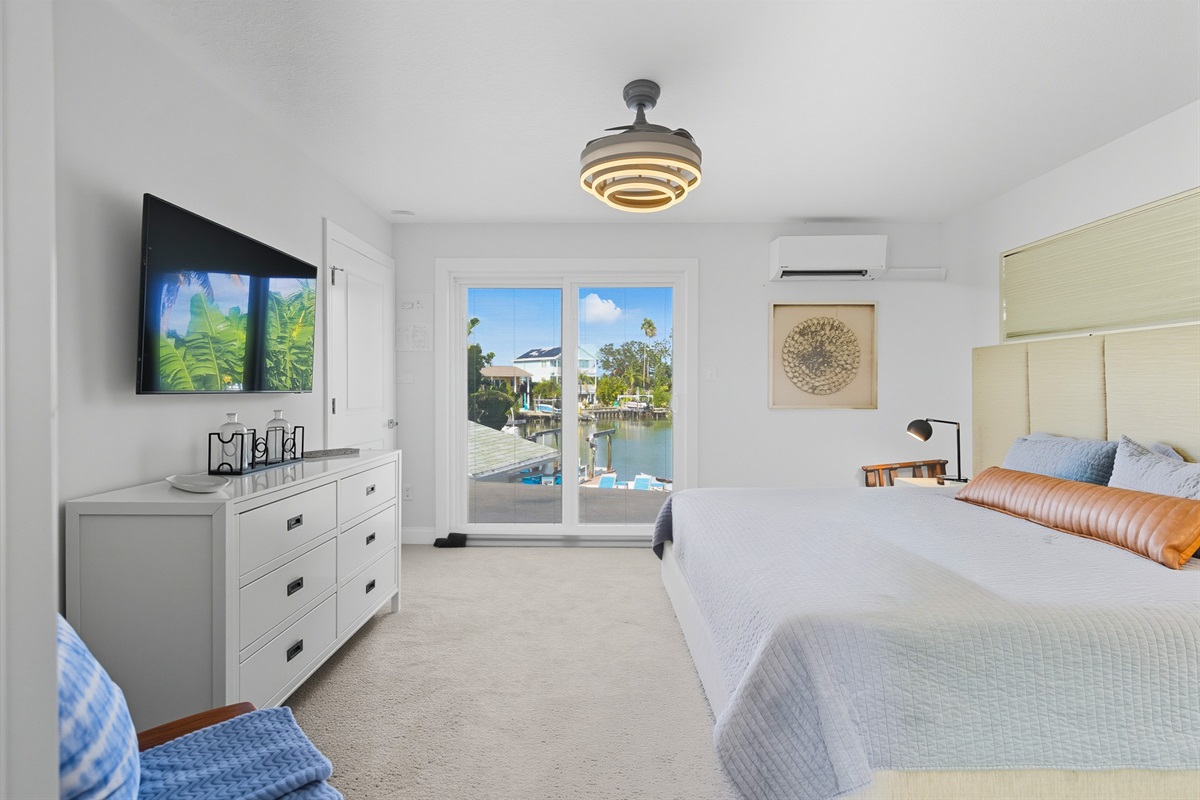 The upstairs master bedroom offers a waterview, king bed, smart TV and en suite bathroom.