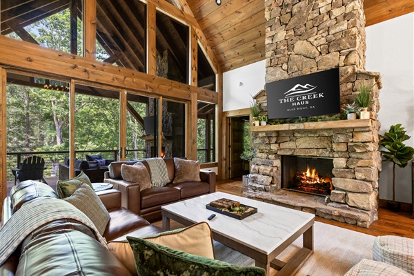 Enjoy breathtaking views of the surrounding woods from the comfort of the main living room’s plush seating.
