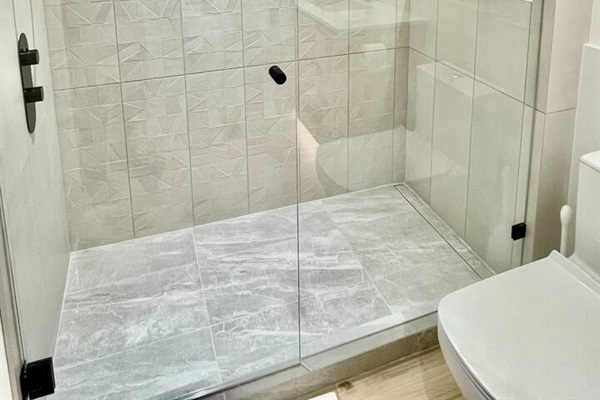 Large walk-in shower w/ rain can shower head and separate wand. Heated floors keeps it cozy.